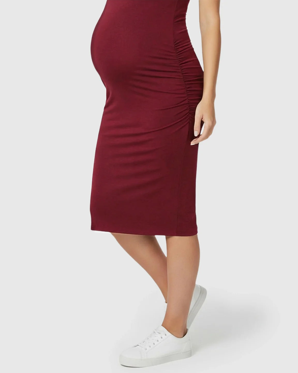 Burgundy sleeveless bodycon maternity dress with side ruching, worn by a pregnant woman.