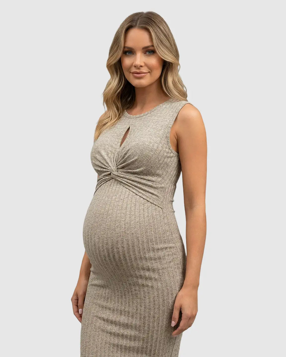 Pregnant woman in a beige ribbed bodycon maternity midi dress with a knotted front and keyhole neckline.