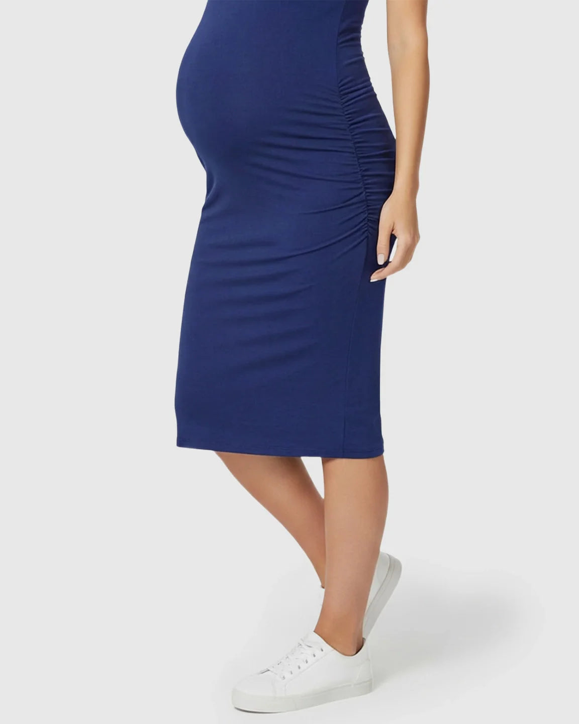 Navy blue sleeveless bodycon maternity dress with side ruching, worn by a pregnant woman.