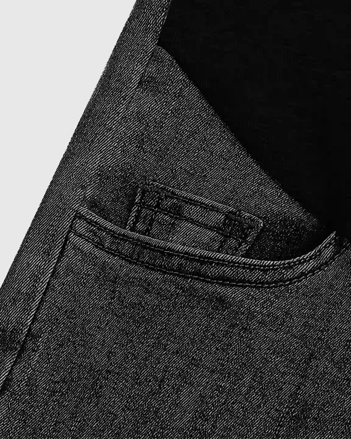 Close-up of dark wash stretch denim straight-leg maternity jeans pocket with stitching details.