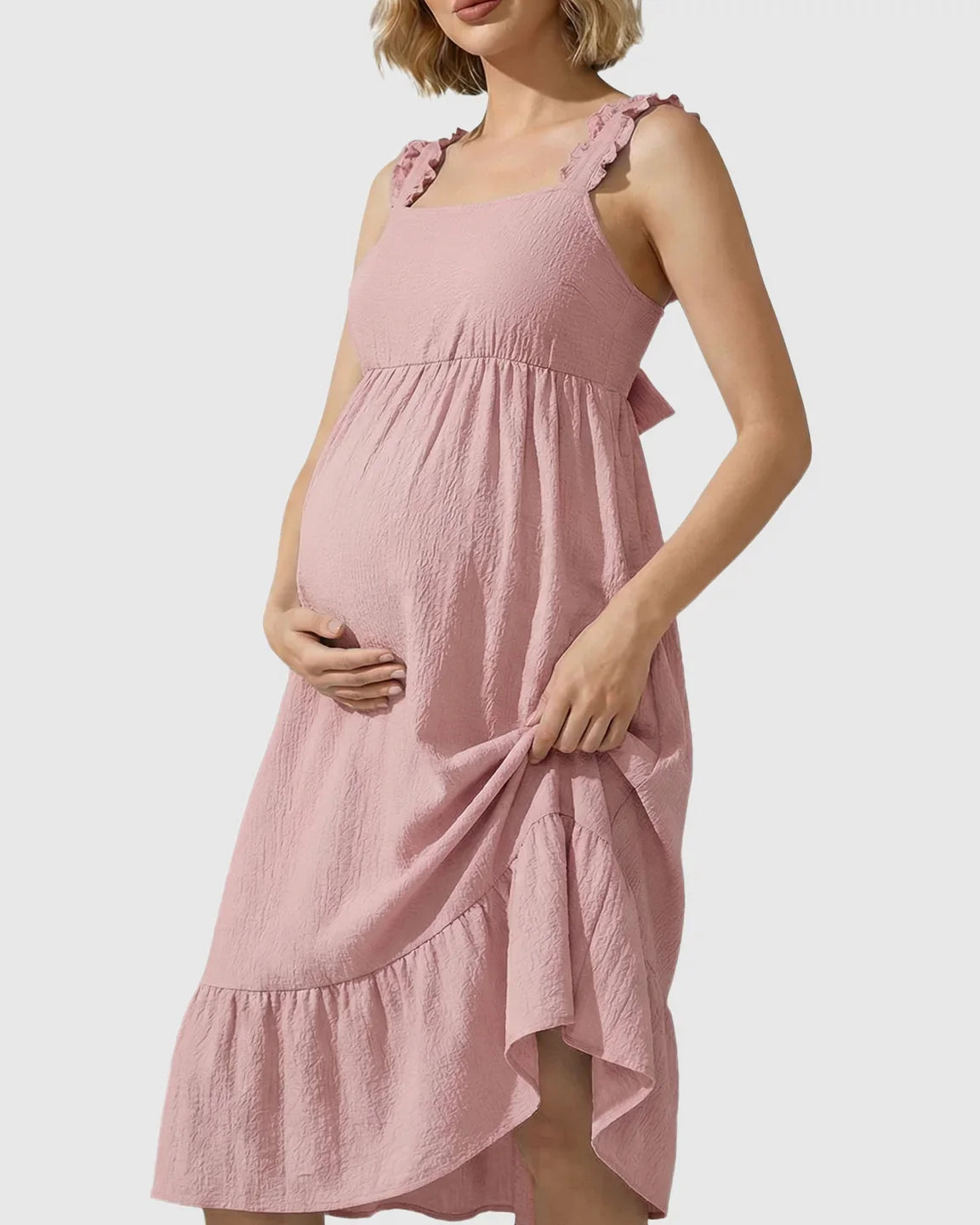 Pink tiered maternity maxi dress with ruffled straps, square neckline, and empire waist.