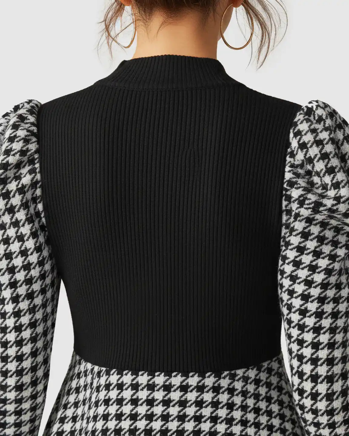 Maternity short dress with black ribbed knit bodice, houndstooth puff sleeves, and a classic skirt.