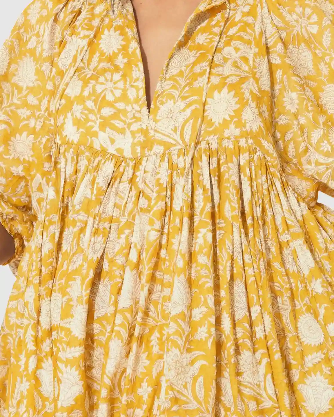 Yellow floral loose-fit maternity midi dress with gathered shoulders, puff sleeves, and a V-neck.