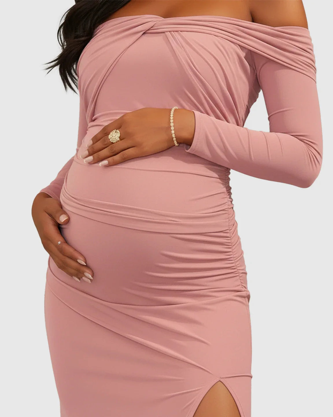 Maternity photoshoot dress: pink ruched off-shoulder bodycon with long sleeves and high slit.