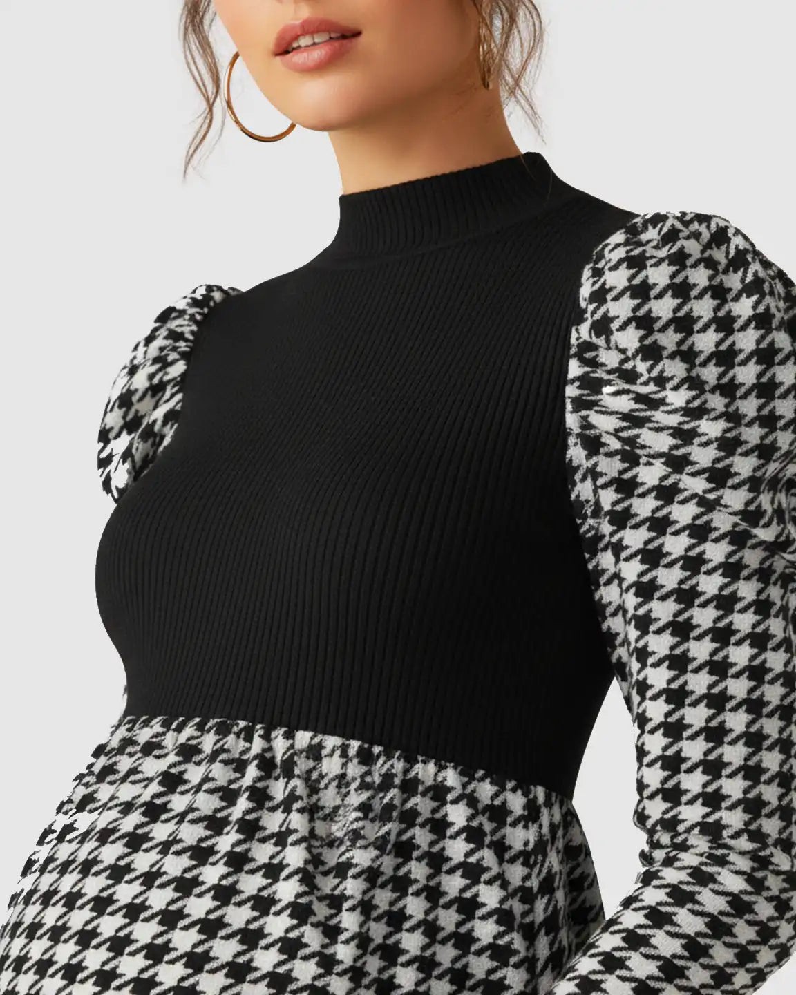 Elegant maternity short dress with black ribbed knit bodice, houndstooth puff sleeves, and skirt.