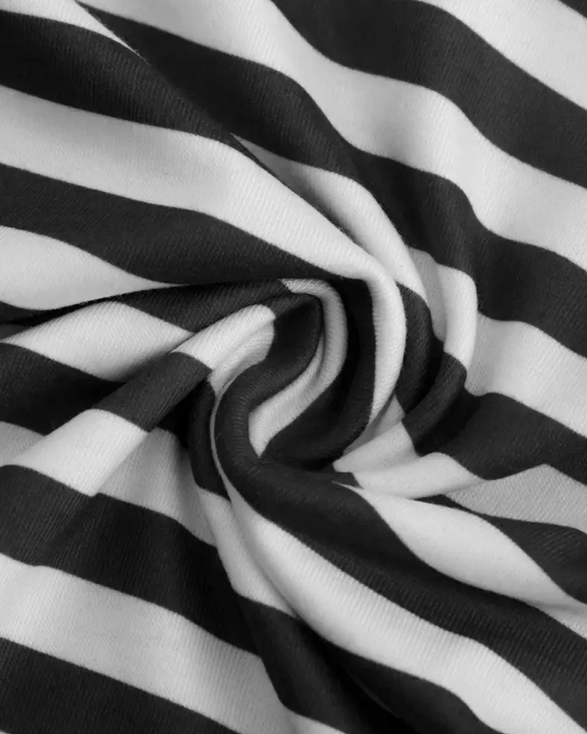 Close-up of a soft, black and white striped loose-fit maternity top fabric, showing its comfortable texture.