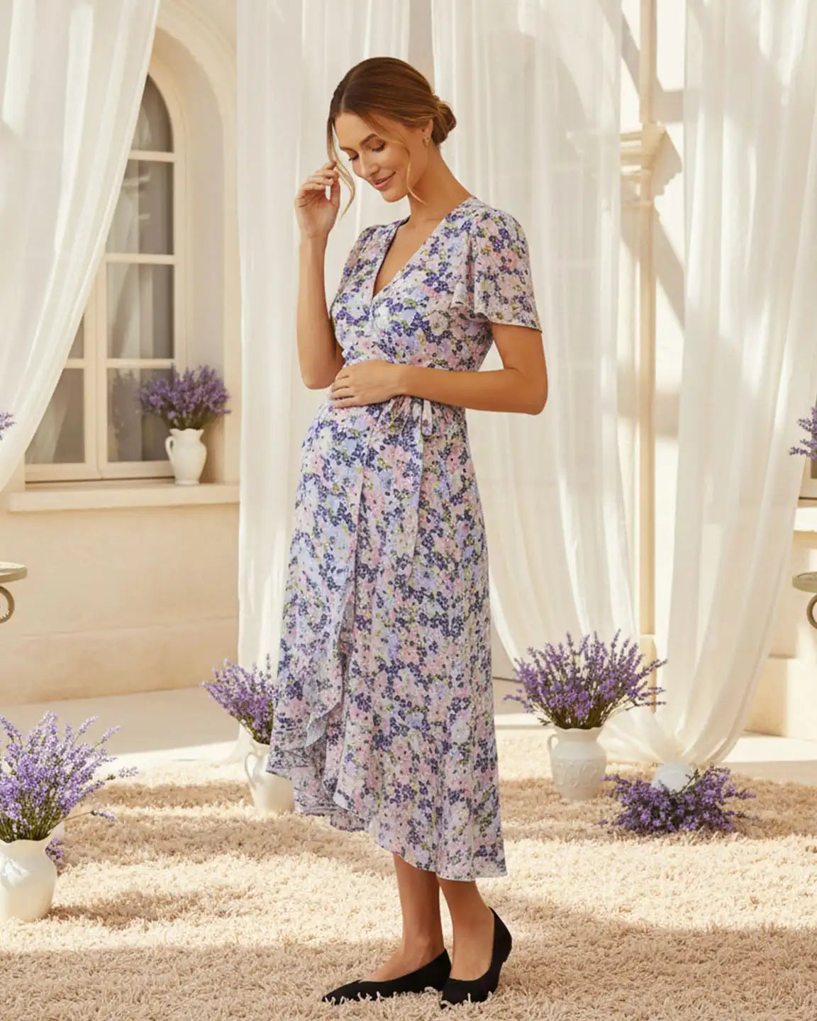 Maternity midi dress: V-neck, wrap-style, light purple floral print, flutter sleeves, and adjustable tie waist.