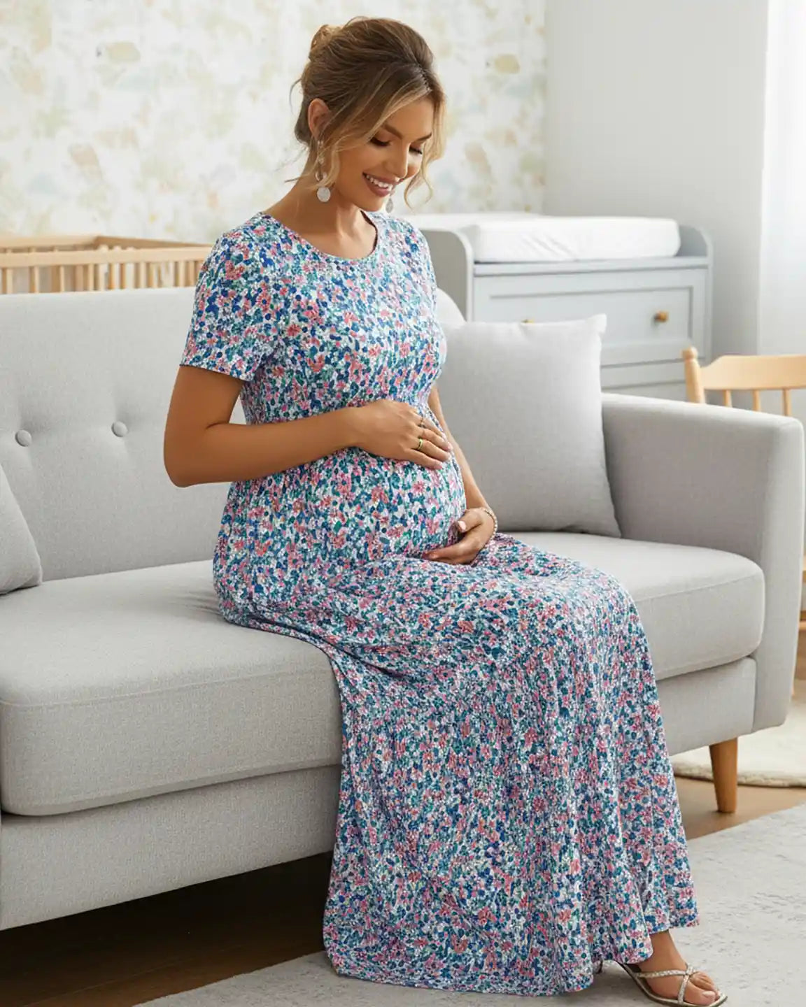 Maternity maxi dress with a round neckline, short sleeves, and a flowing blue and pink floral chiffon skirt.