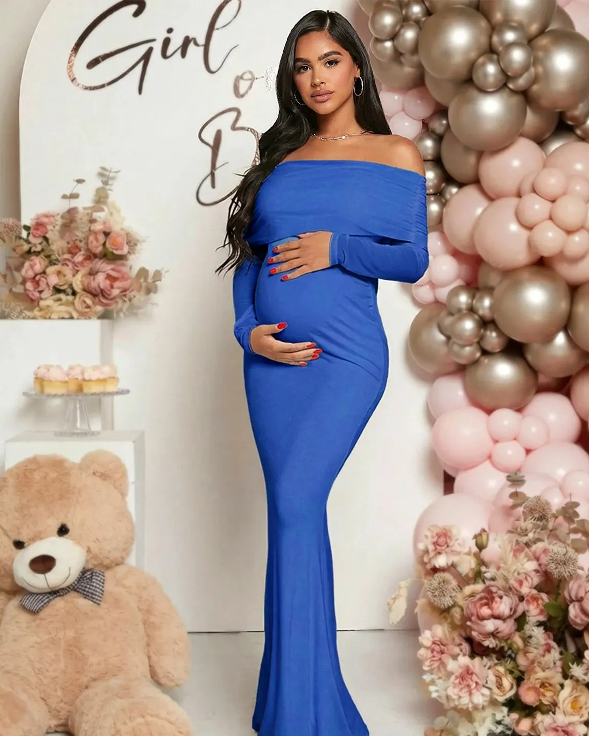 Pregnant woman in a blue off-shoulder draped neck mermaid fit maternity maxi dress, cradling her bump.