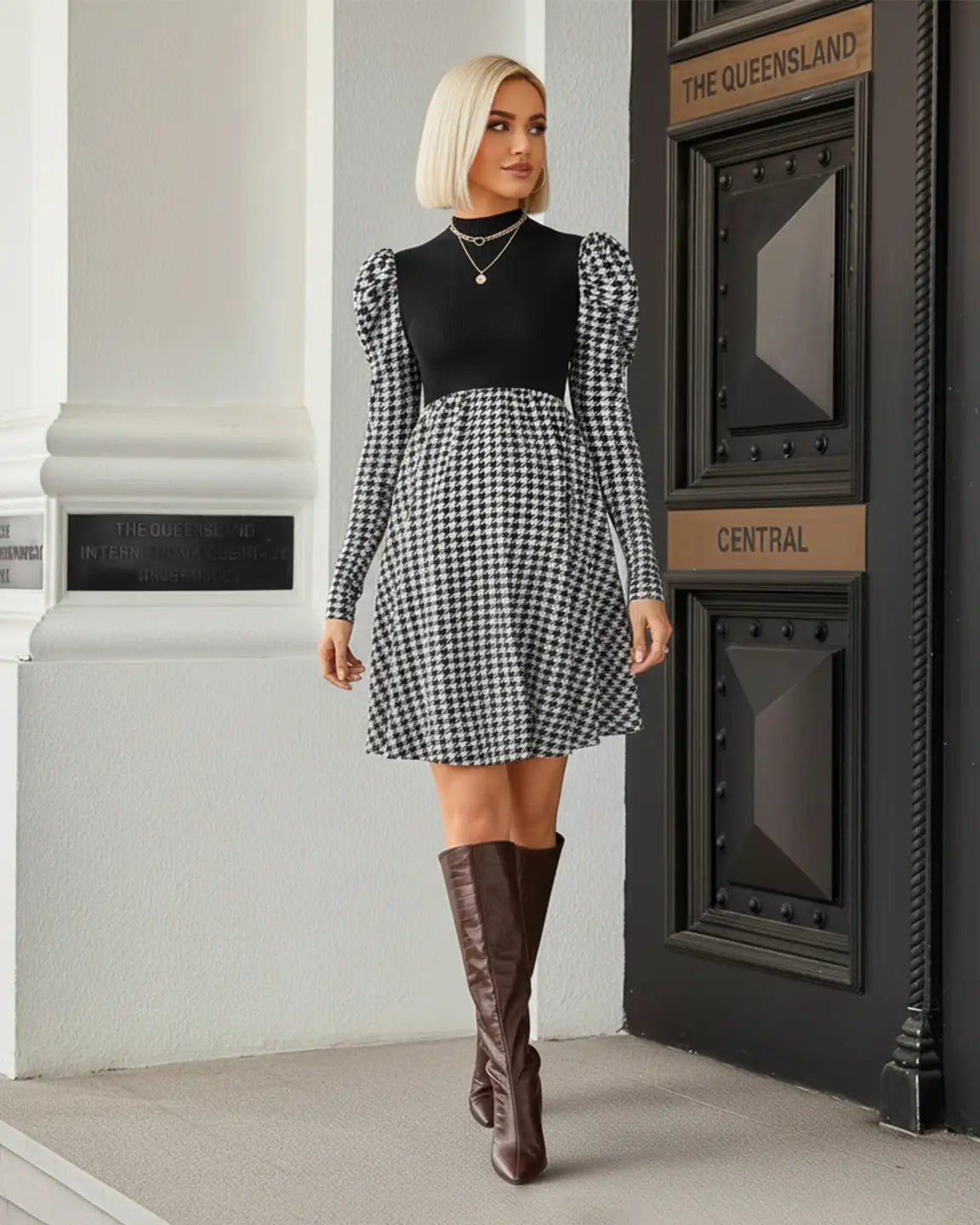 Elegant maternity short dress with black knit bodice, houndstooth skirt, and puff sleeves.