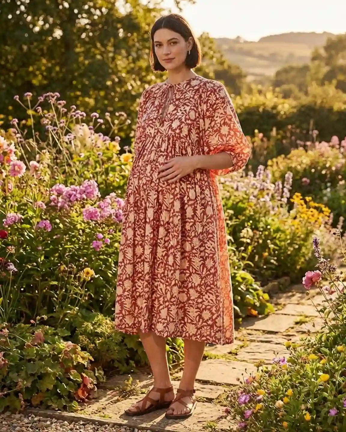 Maternity midi dress in red floral print with gathered shoulders, puff sleeves, and a relaxed fit.