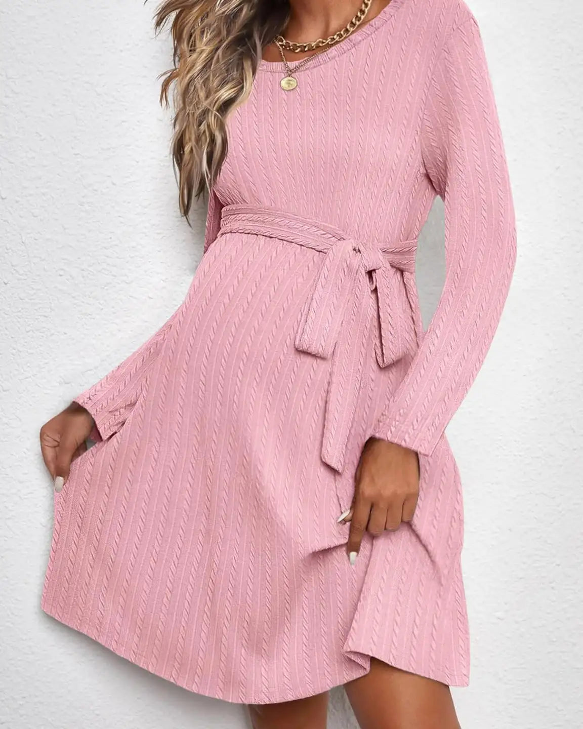 Pink ribbed knit maternity midi dress with long sleeves, round neck, and adjustable tie-waist.