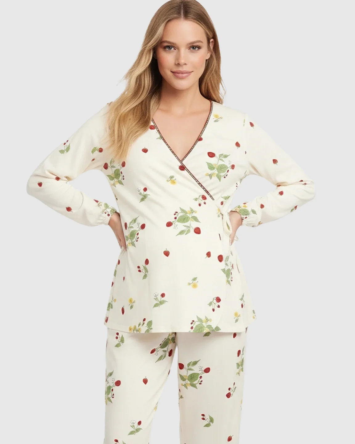 Woman in a cream floral wrap kimono style maternity pajama set with strawberry print.