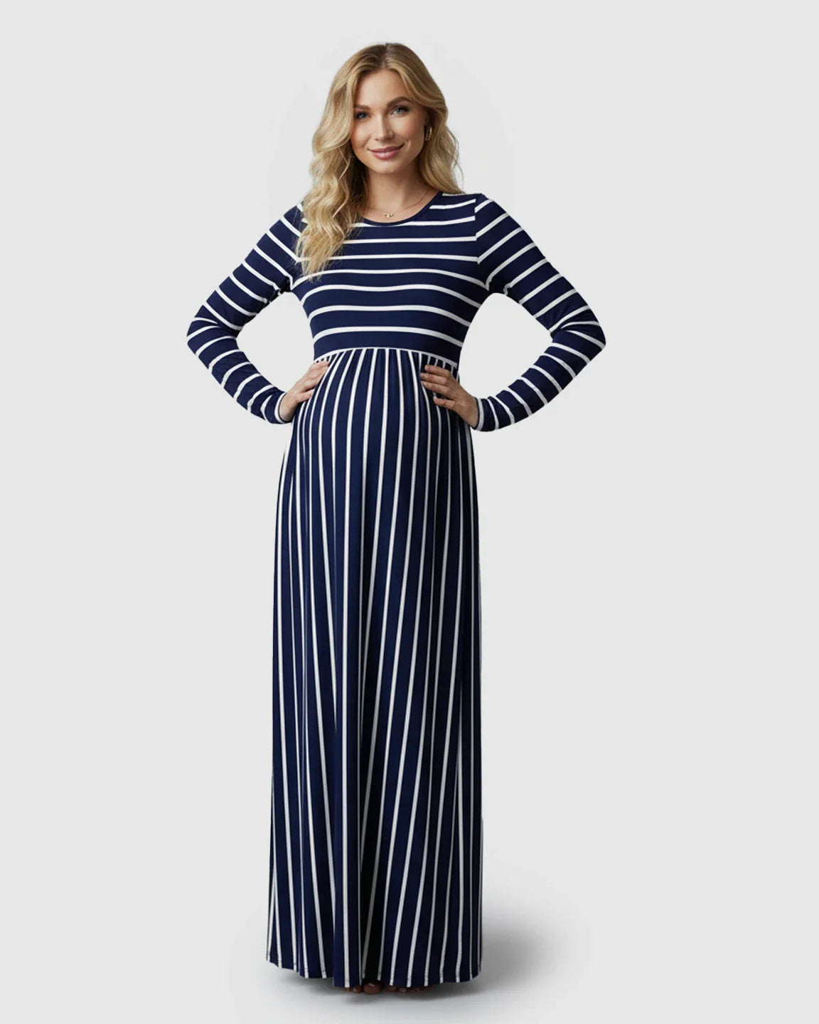 Blonde pregnant woman in a navy and white striped long sleeve maternity maxi dress.