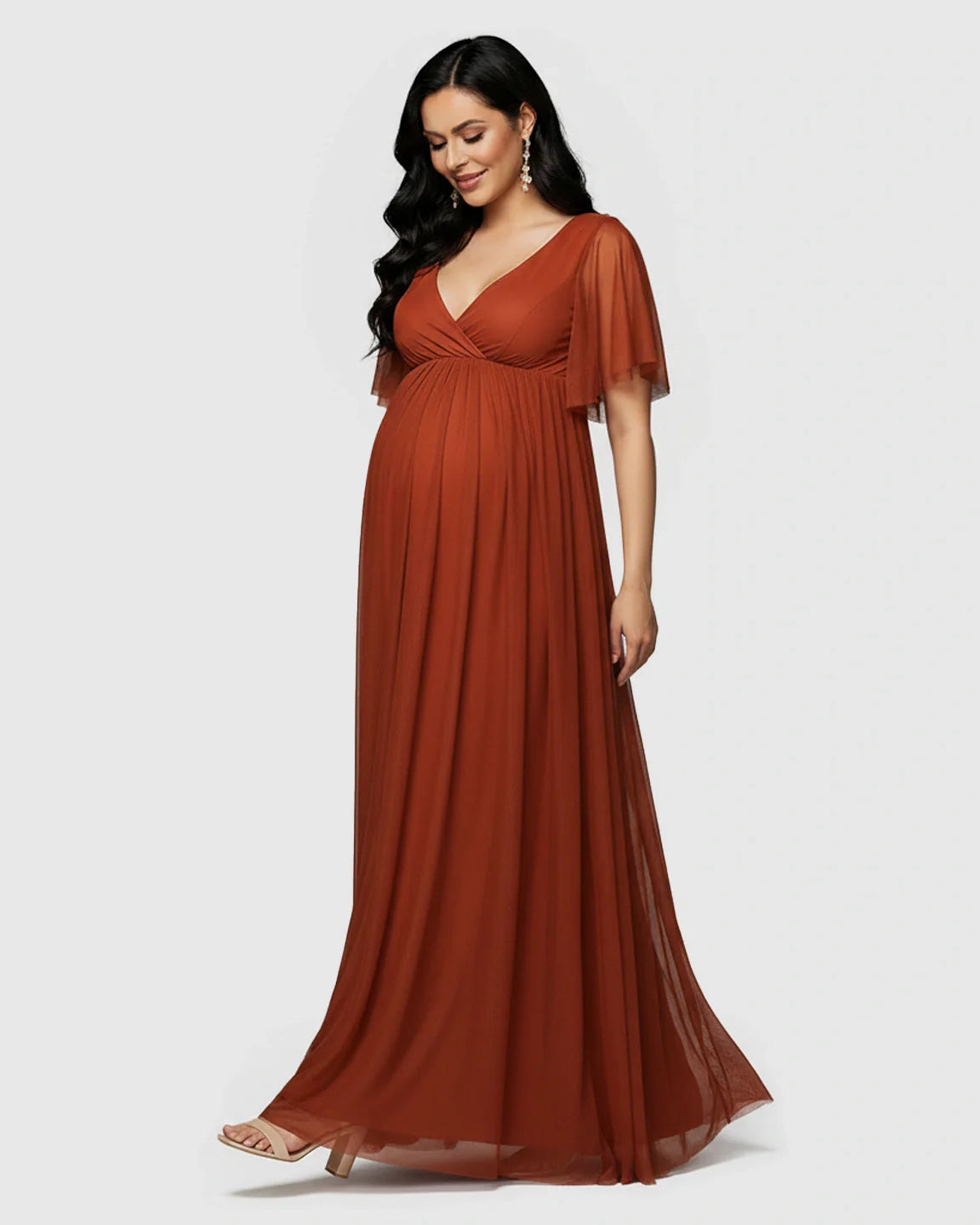 Rust V-neck chiffon empire waist maternity maxi dress with flutter sleeves, flowing over a pregnant woman.