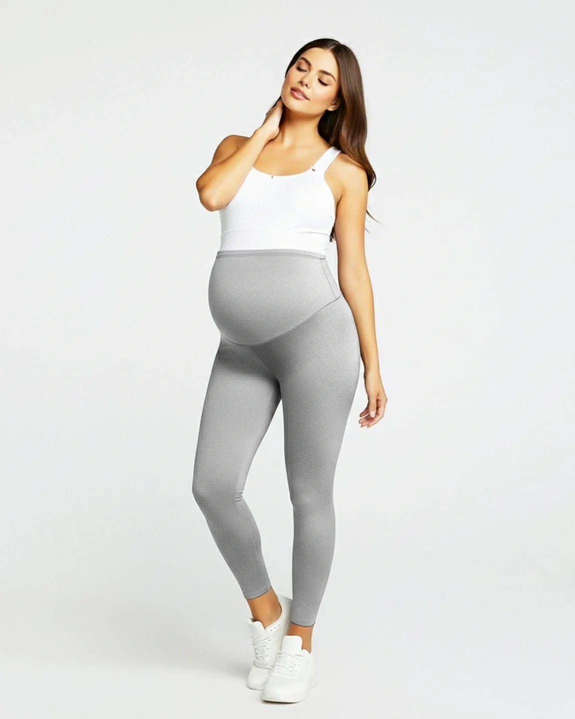 Pregnant woman in light gray sculpting ankle-length maternity leggings with an over-the-bump panel.