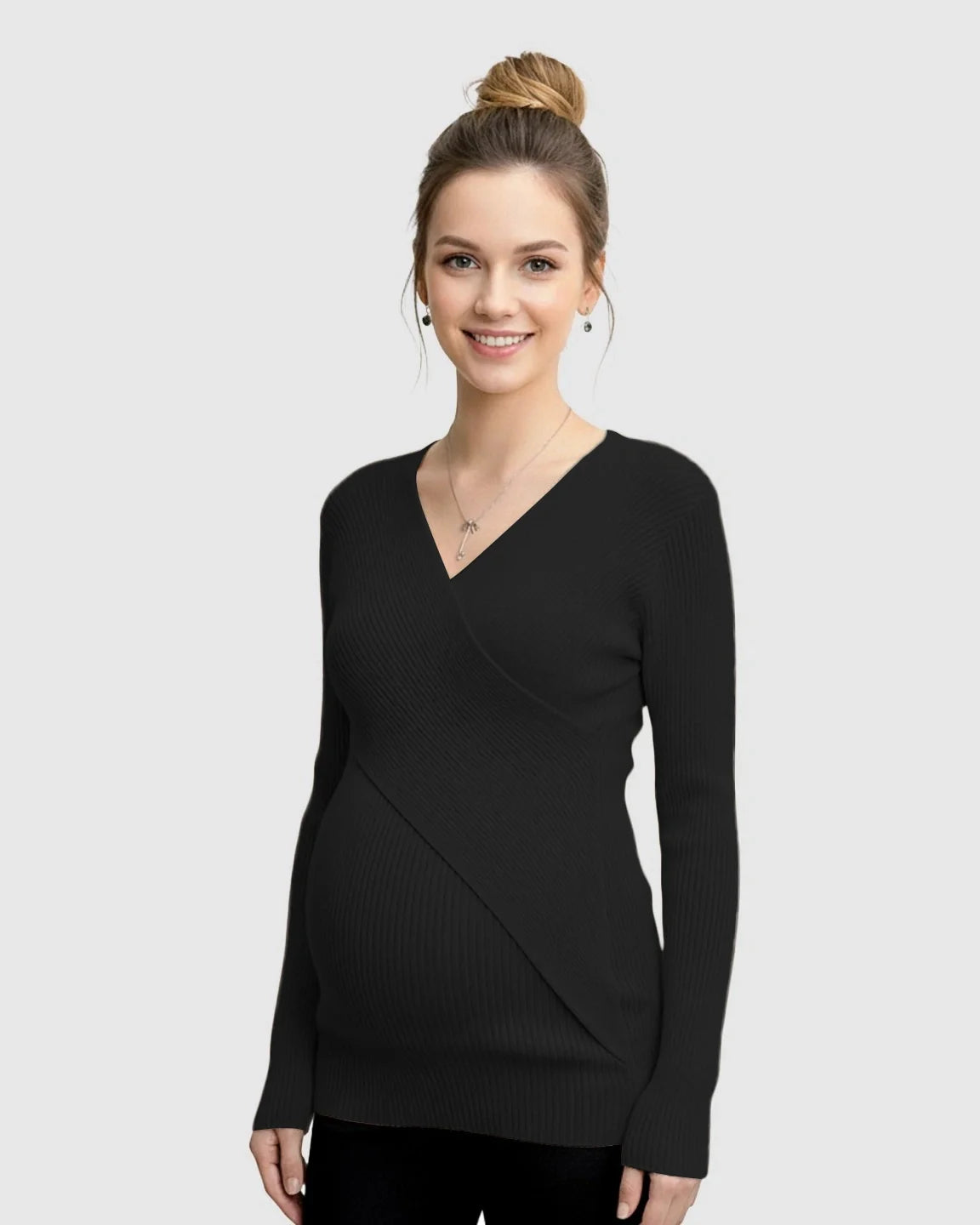 Smiling pregnant woman in a black faux-wrap ribbed maternity top with a V-neck.