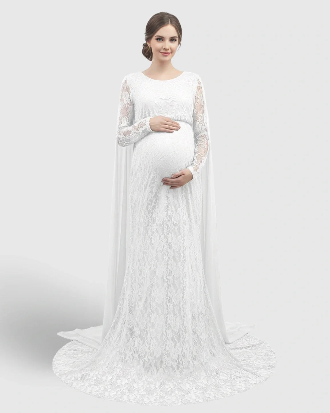 White lace maternity gown with long sleeves, empire waist, and trailing chiffon cape.