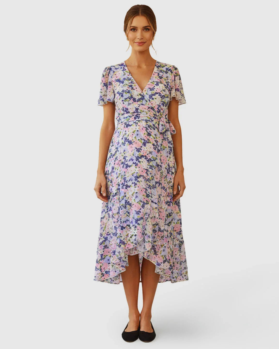 Maternity V-neck wrap-style midi dress with flutter sleeves, adjustable tie waist, and a breezy floral print.