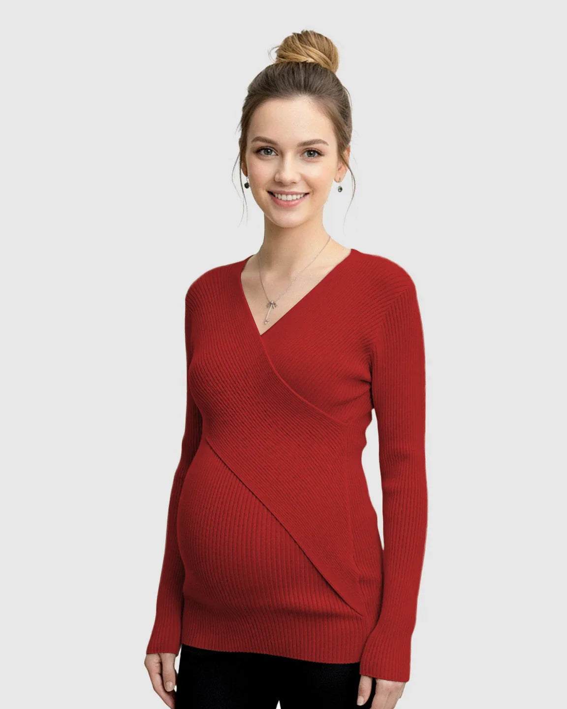 Smiling pregnant woman wearing a red faux-wrap ribbed maternity top with long sleeves.