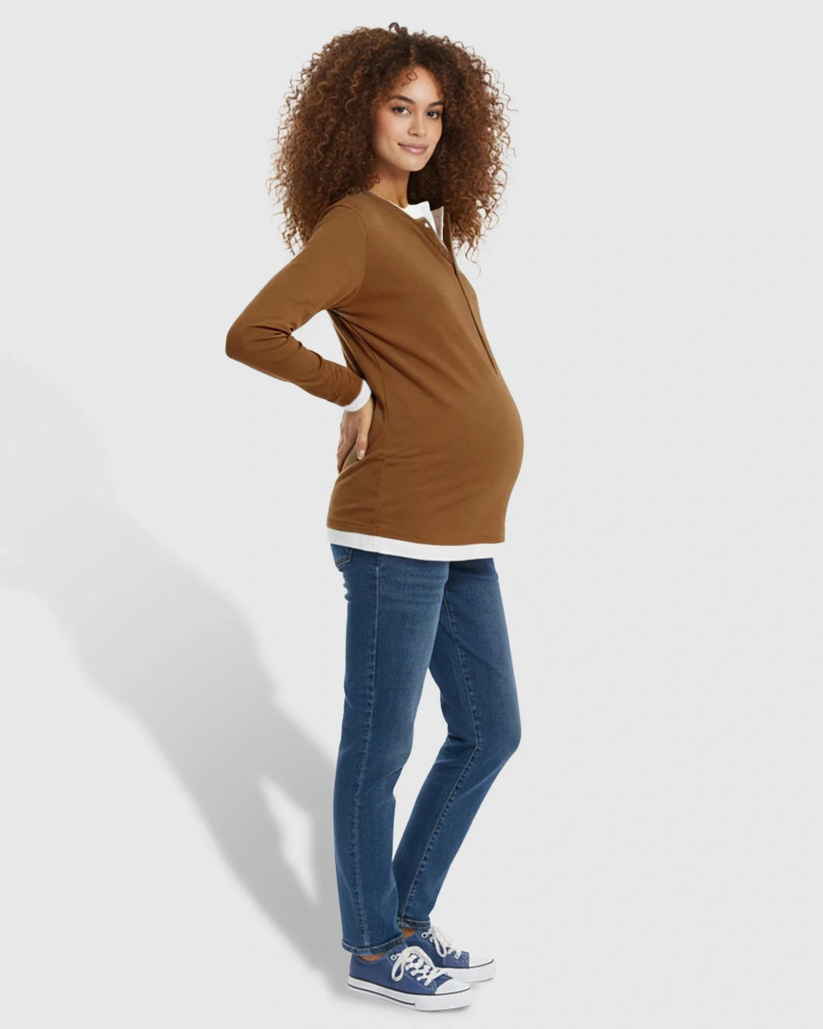 Pregnant woman in a brown long-sleeve button-front henley maternity and nursing top with white trim.