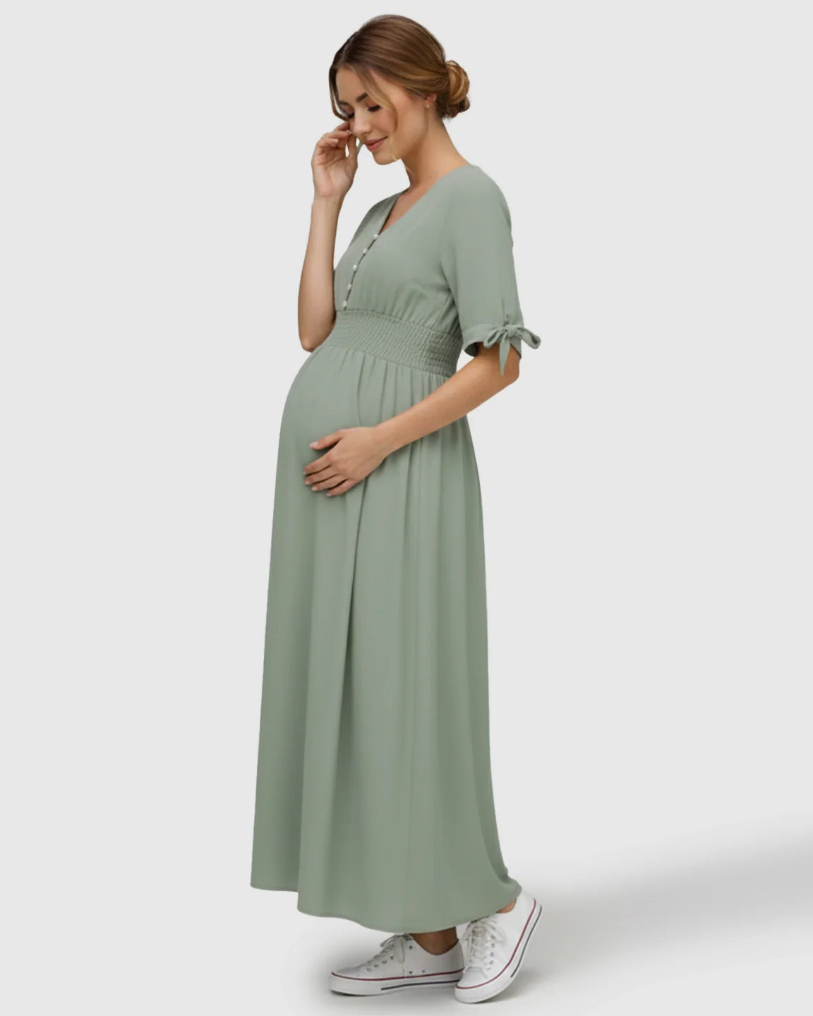 Mint green V-neck empire waist maternity maxi dress with buttons, short sleeves, and tie details.