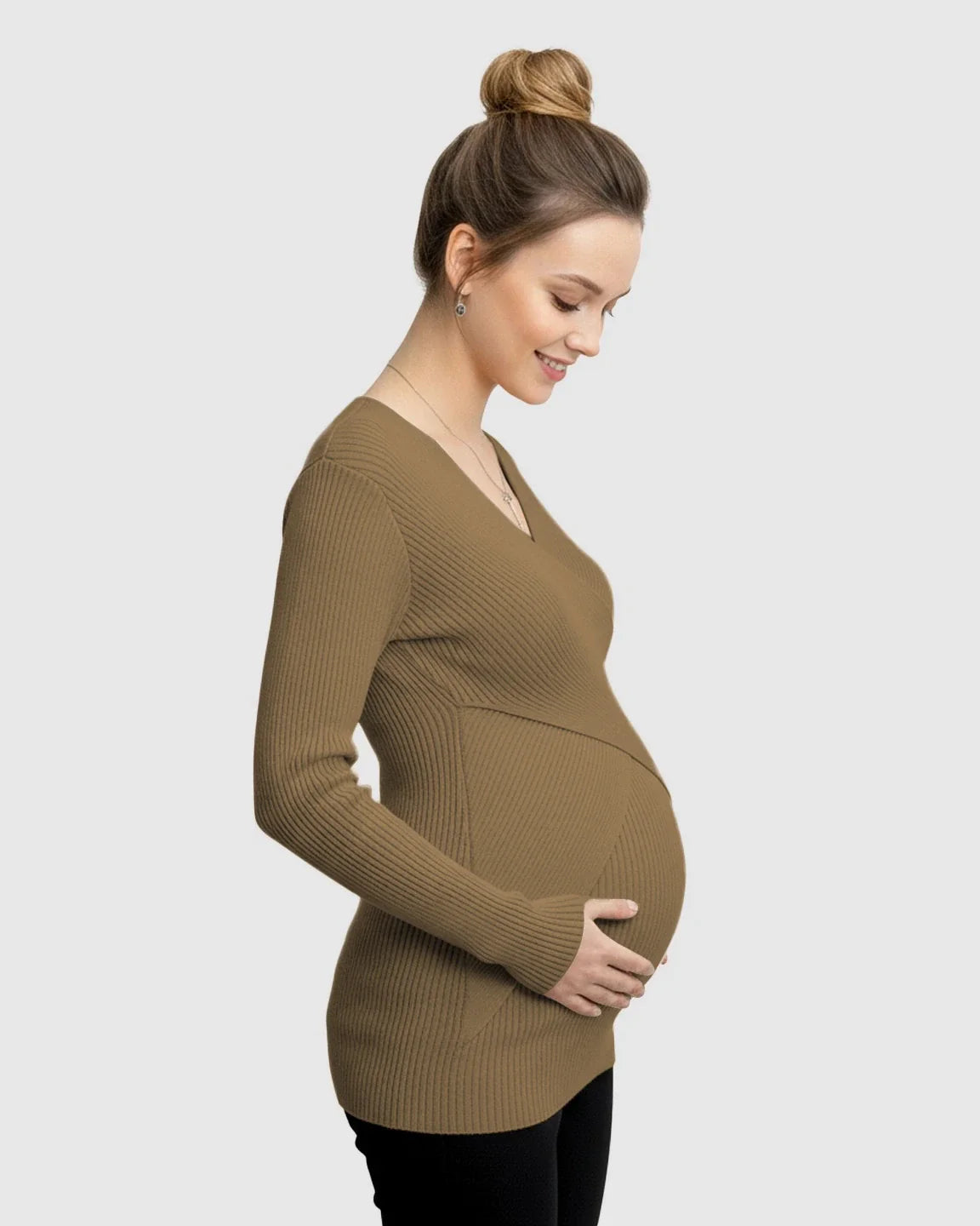 Pregnant woman in a brown ribbed faux-wrap maternity top, long sleeves, v-neck, smiling and holding her bump.