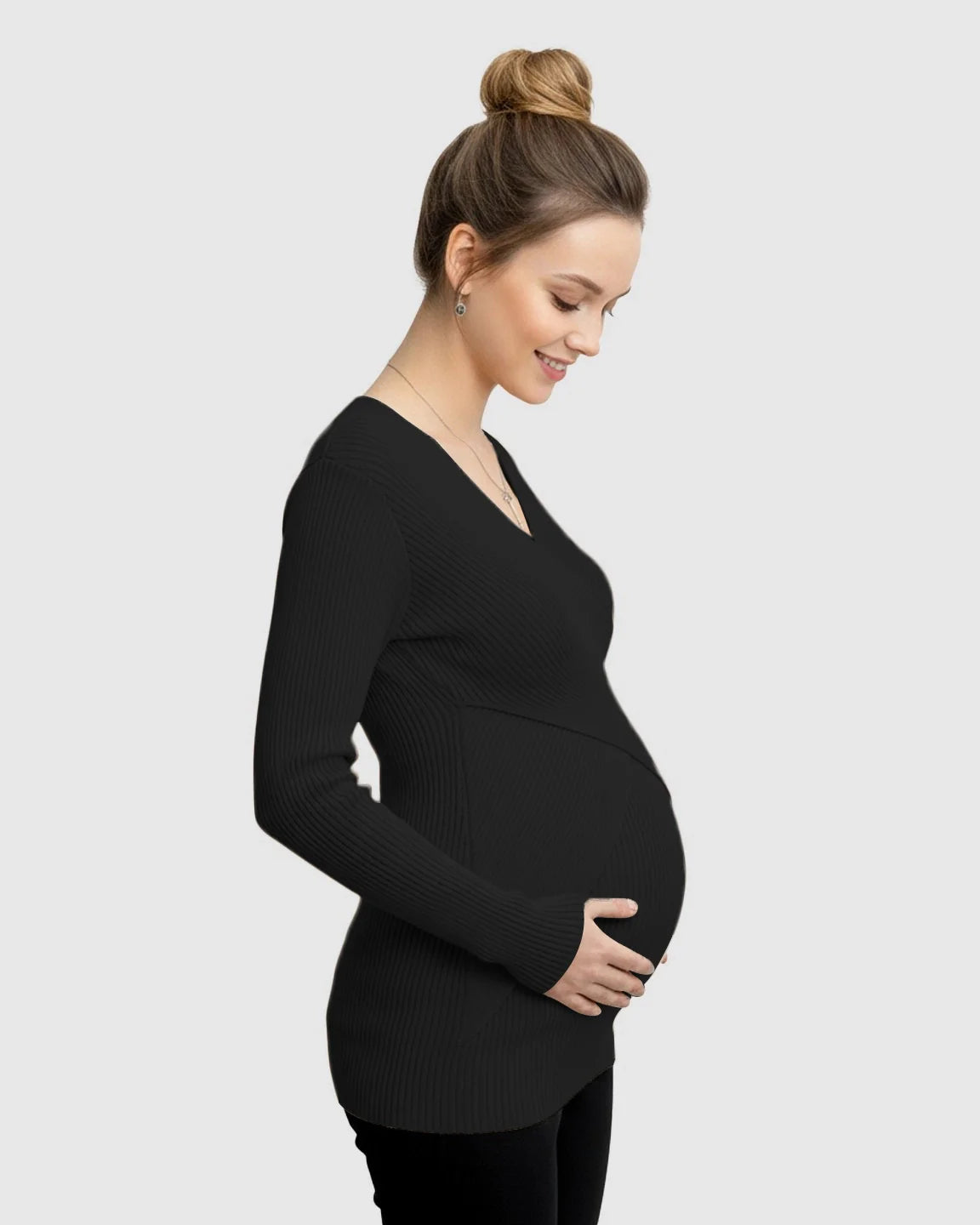 Smiling pregnant woman in a black faux-wrap ribbed maternity top with a V-neck, long sleeves, and a comfortable fit.