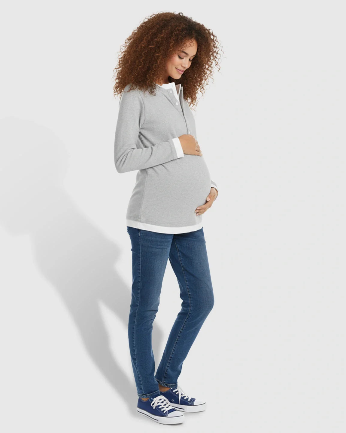 Pregnant woman in a gray long-sleeve button-front henley maternity and nursing top with white trim.