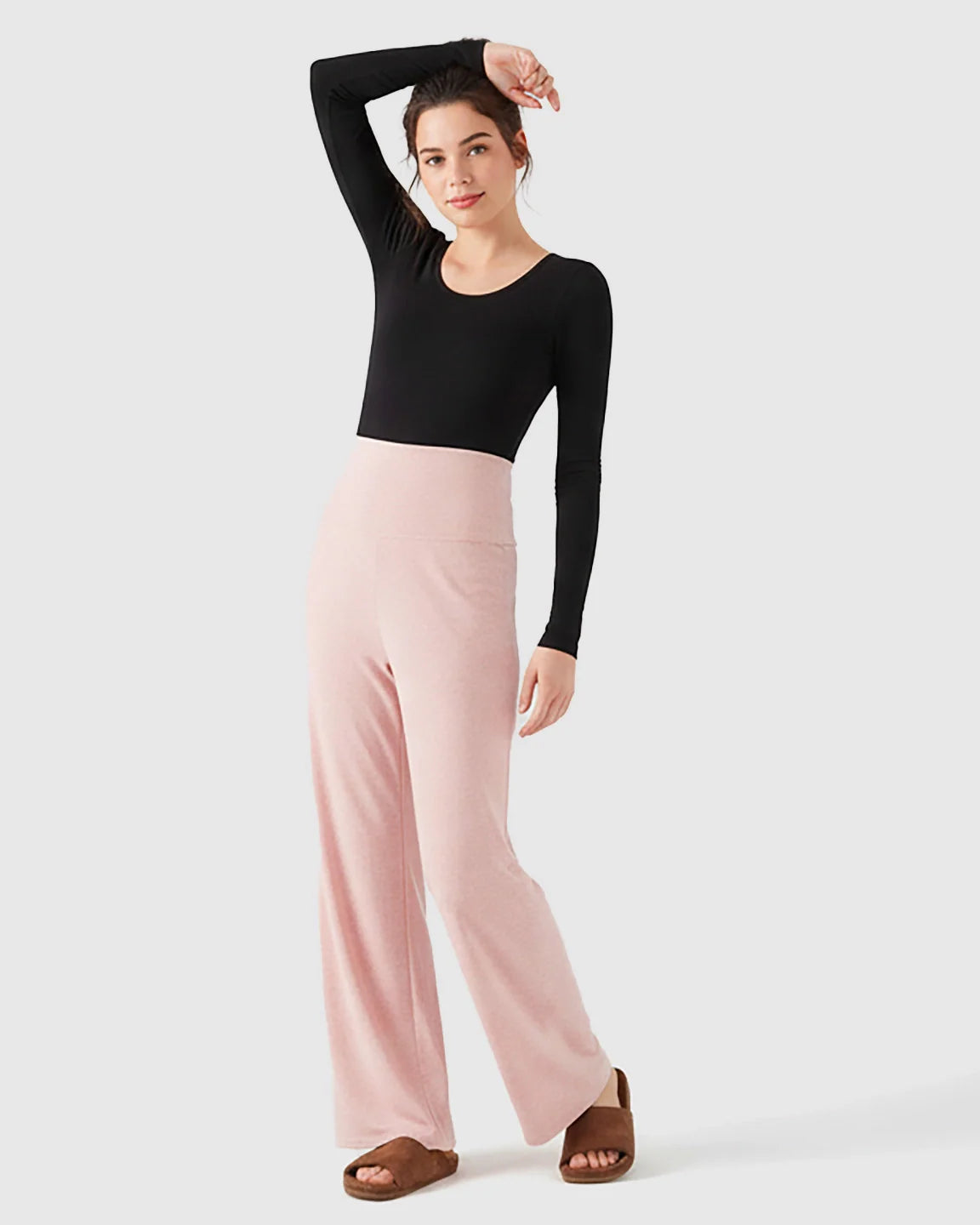 Woman in pink fleece wide-leg maternity pants with over-belly waistband and black long-sleeve top.