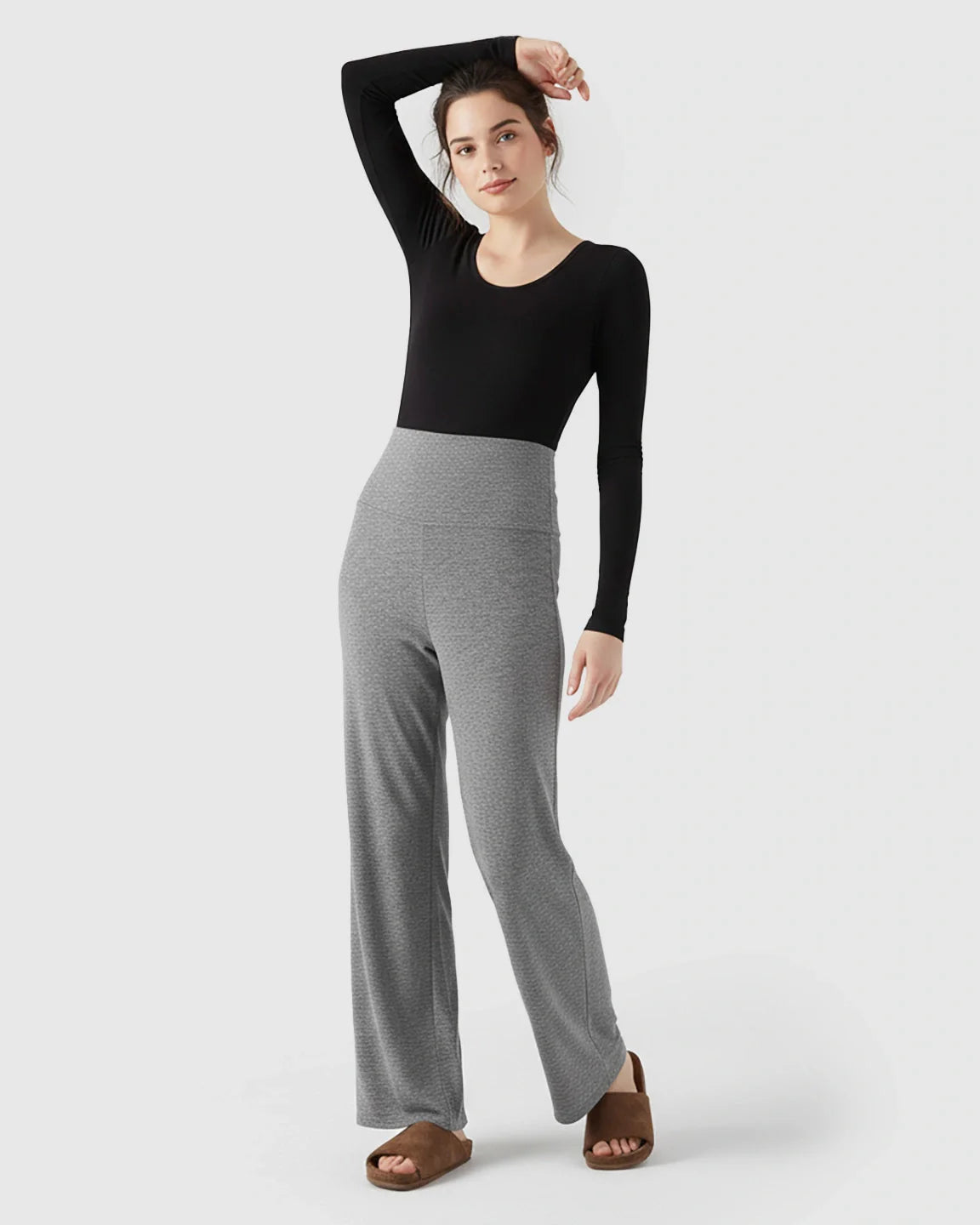 Model wearing gray fleece-lined maternity pants with an over-belly waistband and wide-leg design.