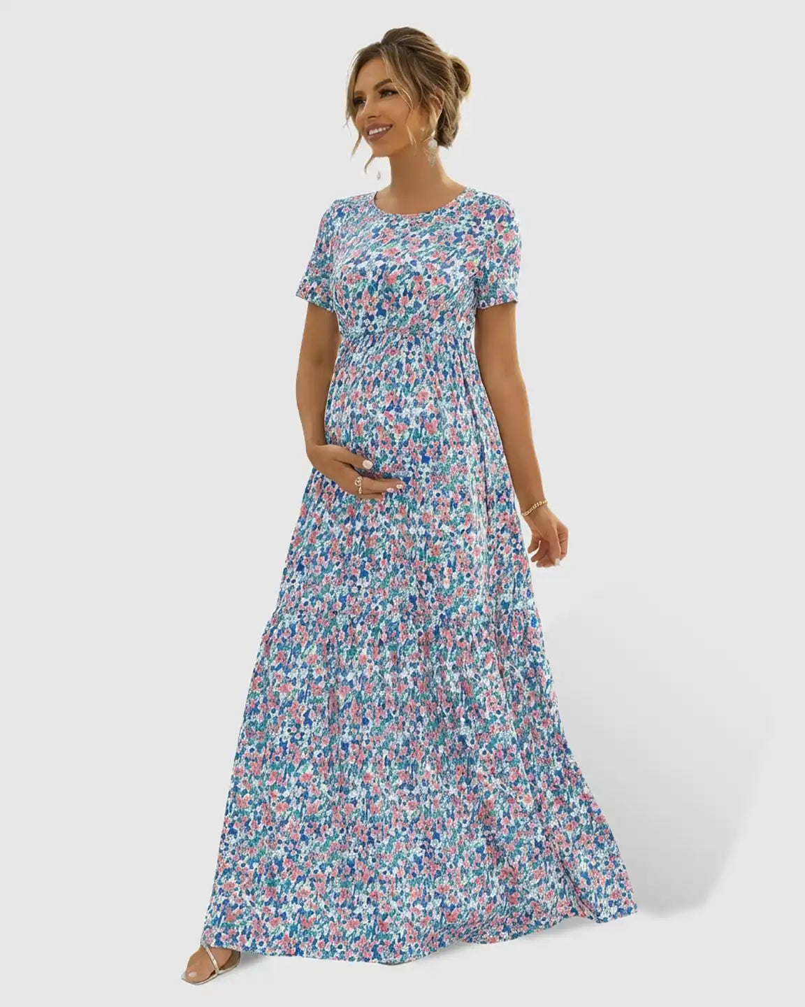 Maternity maxi dress with short sleeves, round neck, and a flowing blue, pink, and green floral chiffon skirt.