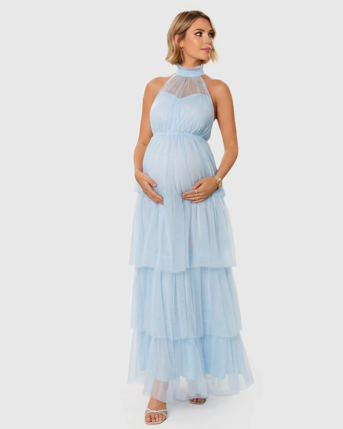 Light blue halter neck tiered mesh maternity gown, floor-length with a romantic, cloud-like skirt.