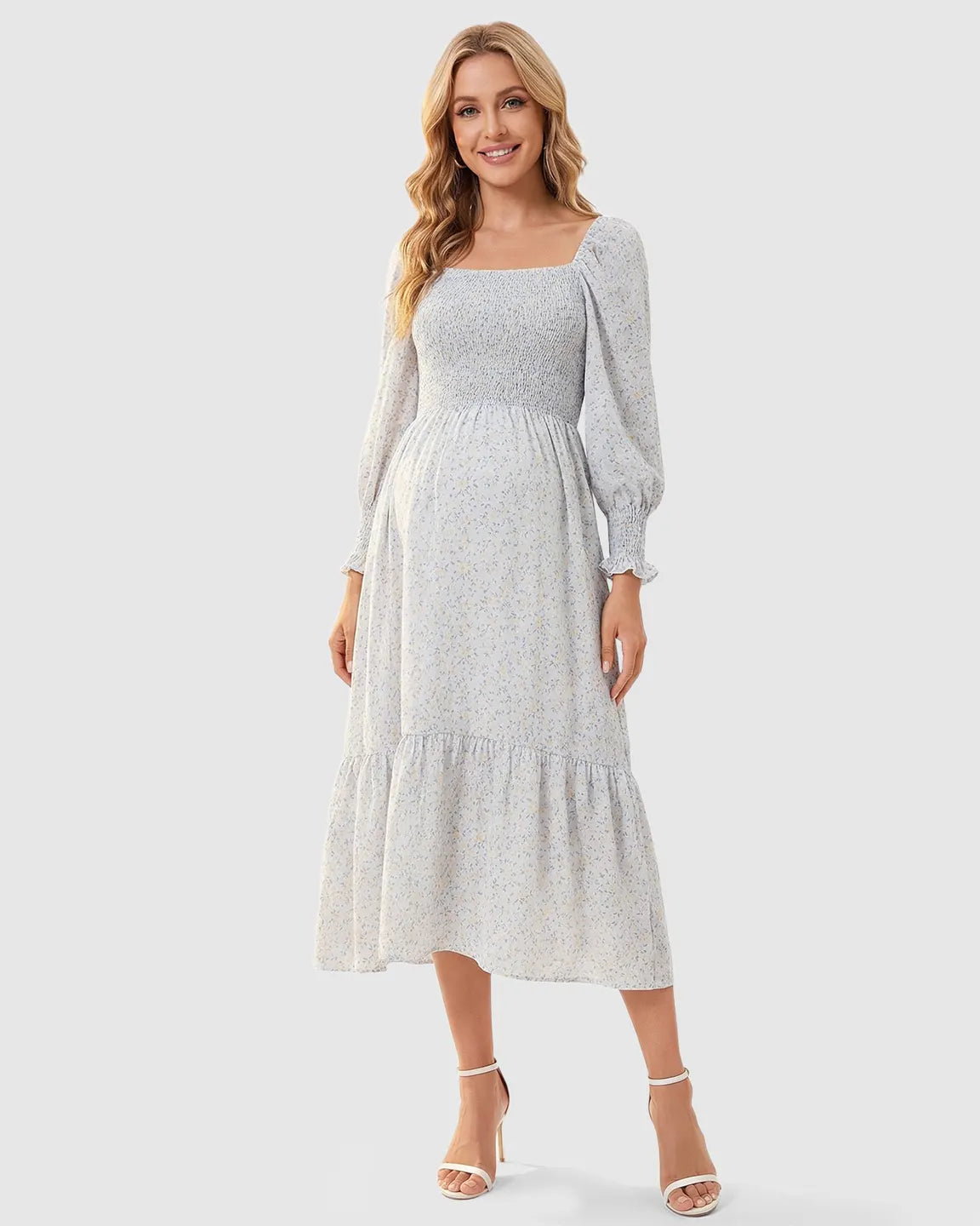 Smocked floral long sleeve maternity midi dress in light blue with yellow flowers, square neckline, and ruffled hem.