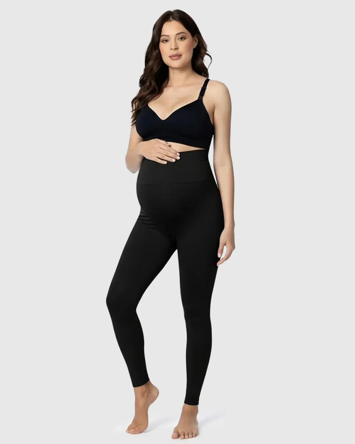 Pregnant woman in black Bump Society Belly Support Stretch Maternity Leggings with high waist panel.