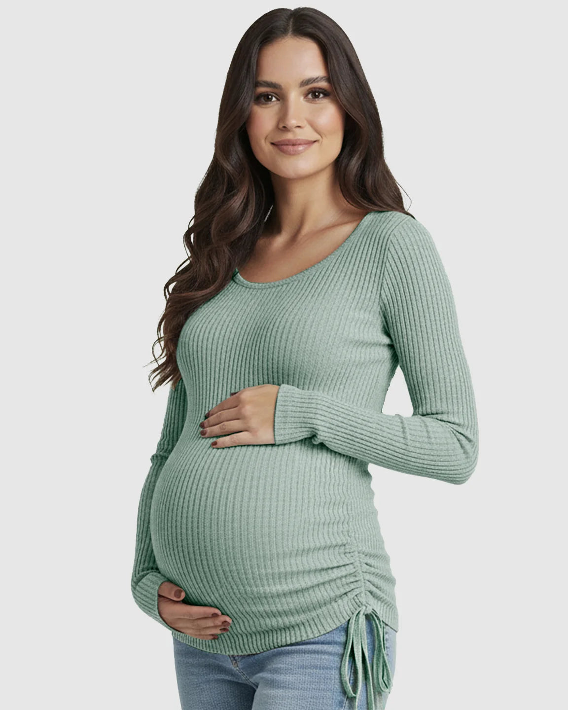 Pregnant woman in a mint green ribbed long-sleeve maternity top with adjustable side drawstrings.