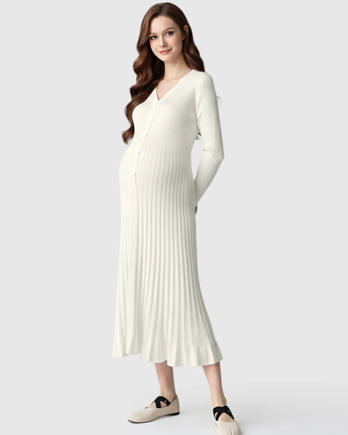Pregnant woman in a white long-sleeve ribbed knit maternity midi dress with a V-neck and front buttons.