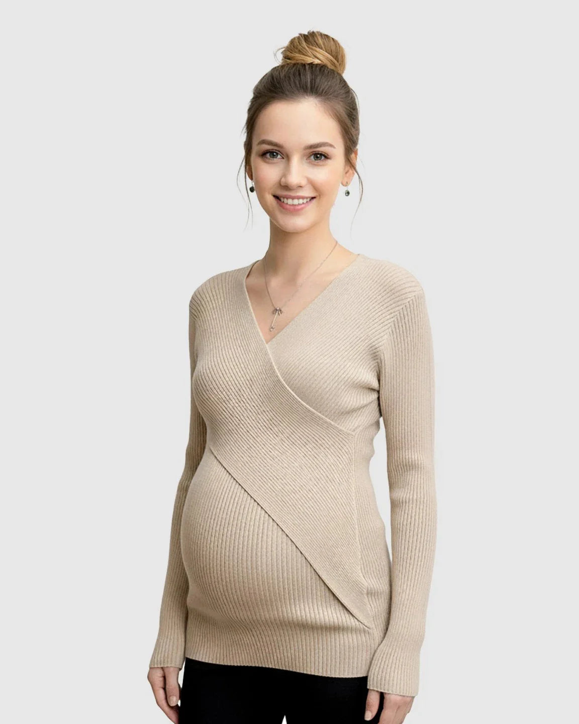 Smiling pregnant woman wearing a beige faux-wrap ribbed knit maternity top.