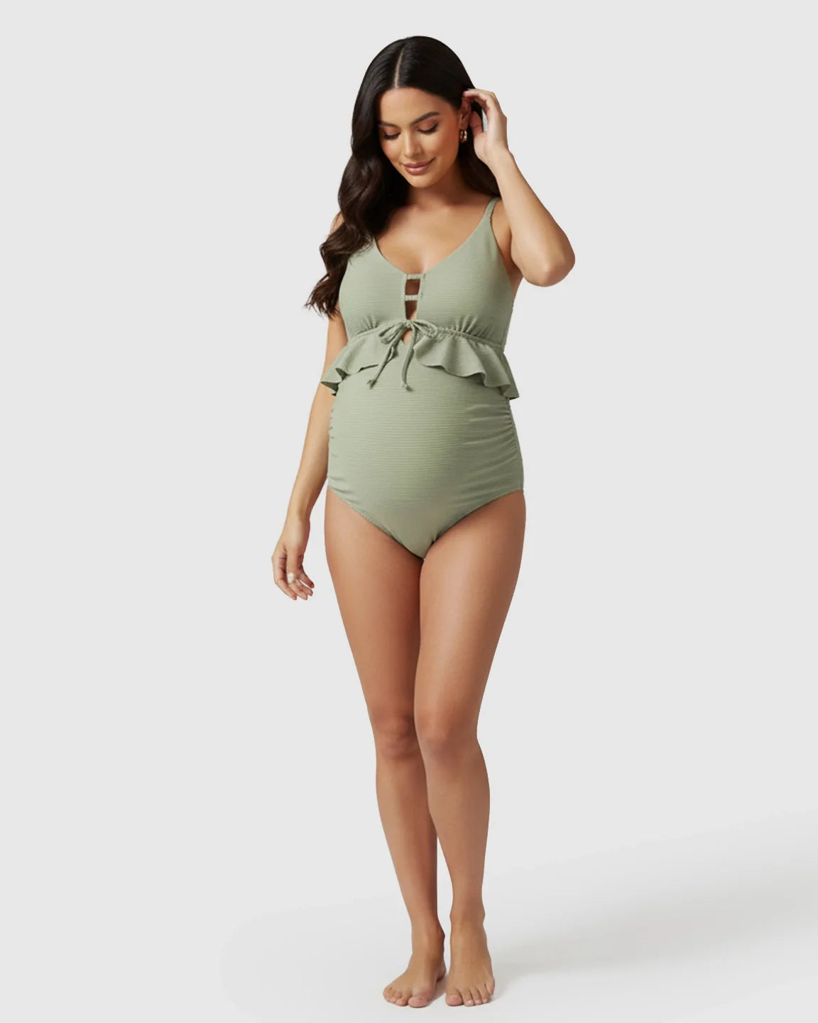 Sage green ribbed maternity tankini swimsuit with ruffle detail, V-neck, keyhole tie, and ruched sides.