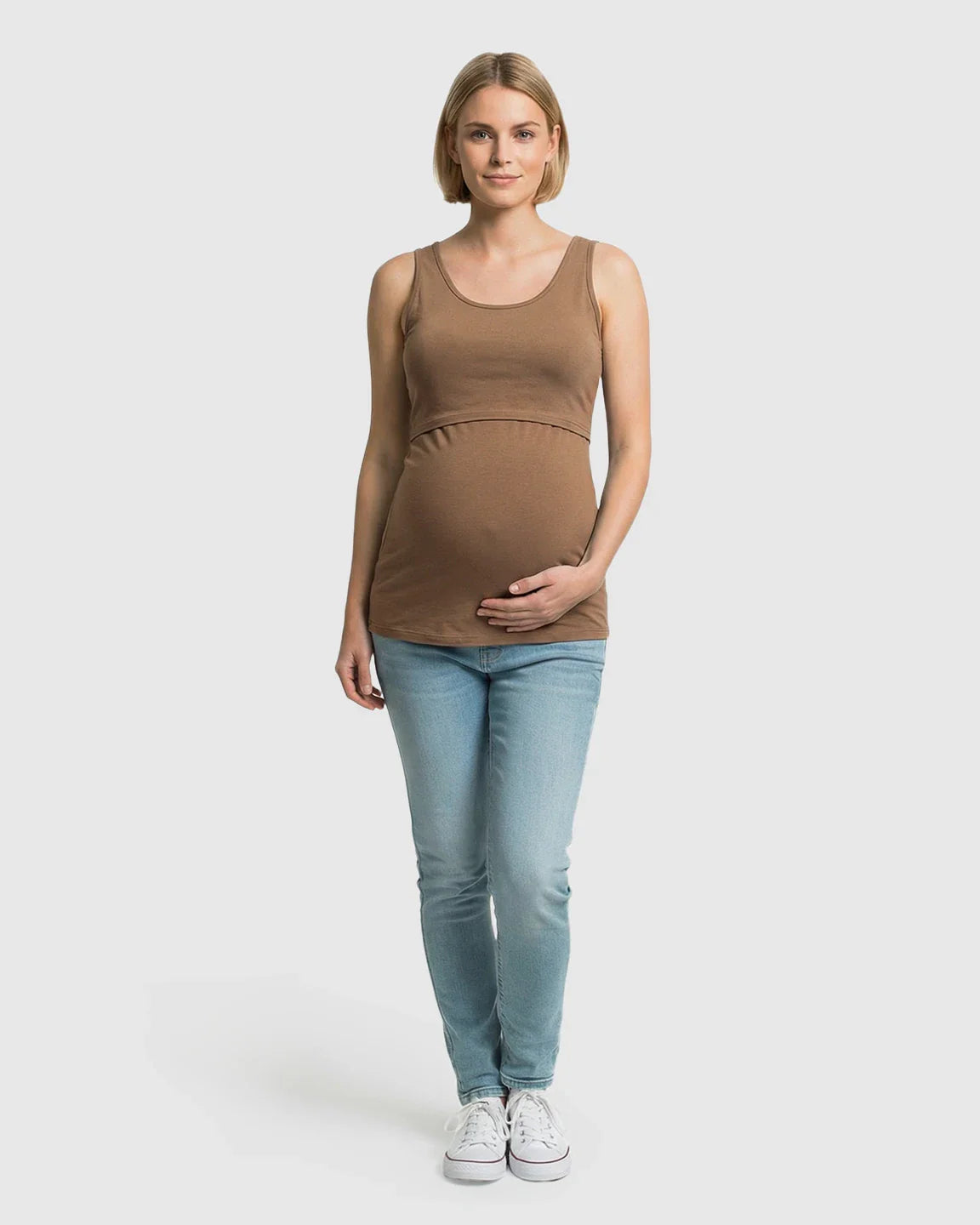 Pregnant woman in a brown stretch nursing-access maternity tank top and light wash jeans.