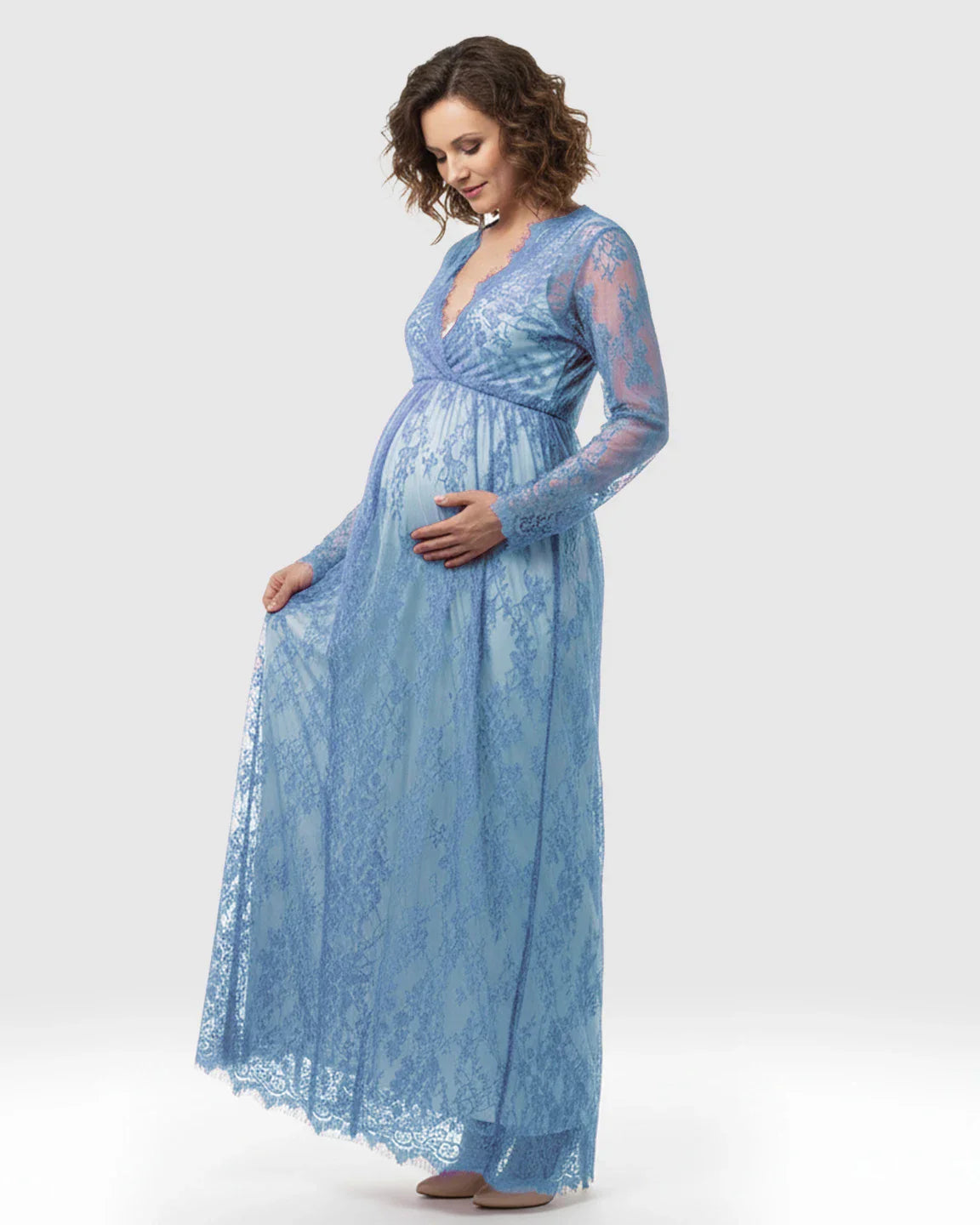 Maternity maxi dress in sheer blue floral lace with V-neck, long sleeves, and empire waist.