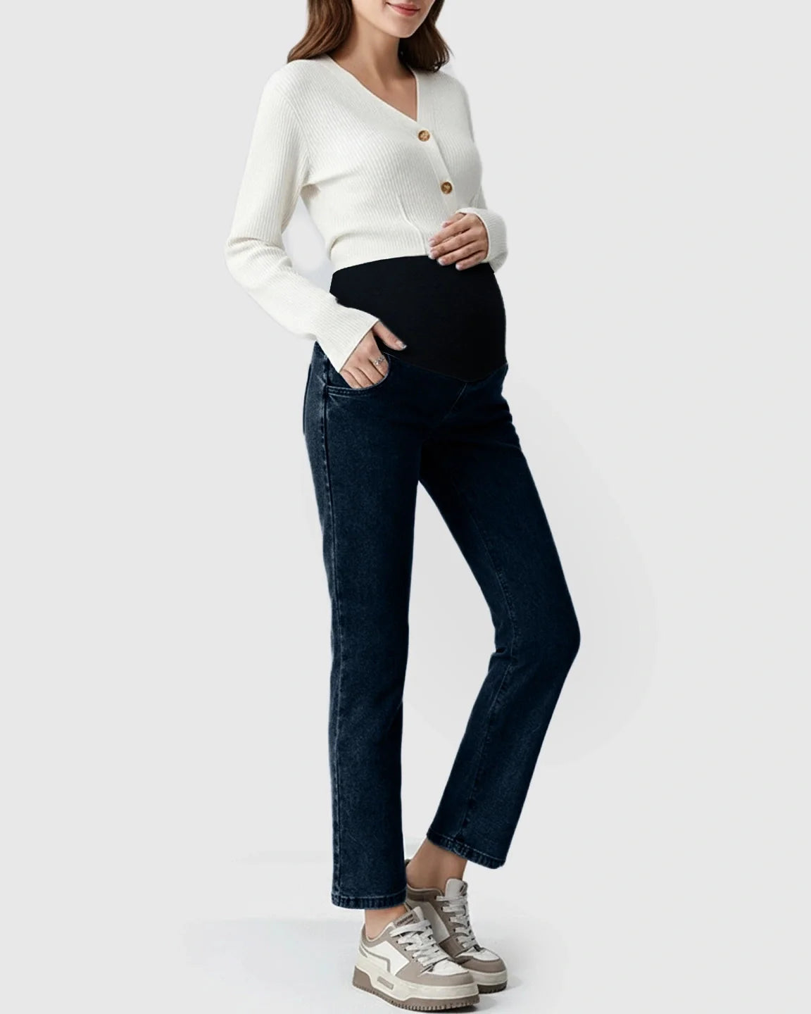Pregnant woman in dark wash stretch denim straight-leg maternity jeans with a black belly band.