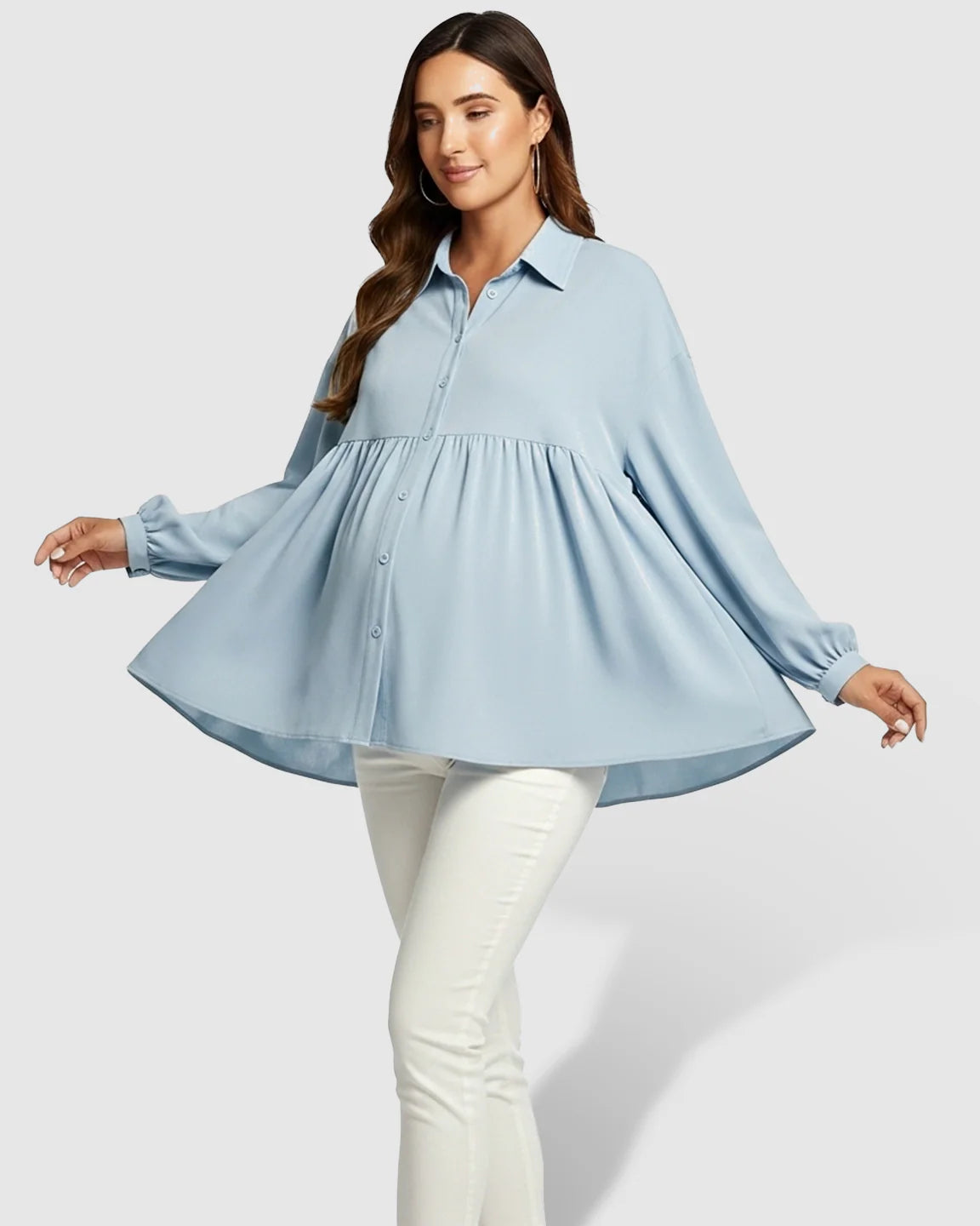 Maternity model in light blue chiffon lapel long sleeve babydoll shirt with button-down front, worn over white pants.