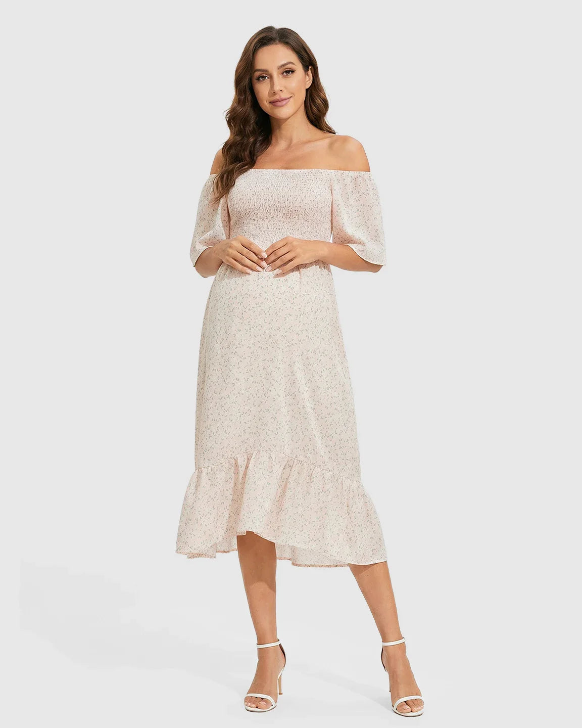 Light pink floral off-shoulder smocked maternity midi dress with flutter sleeves and tiered skirt.