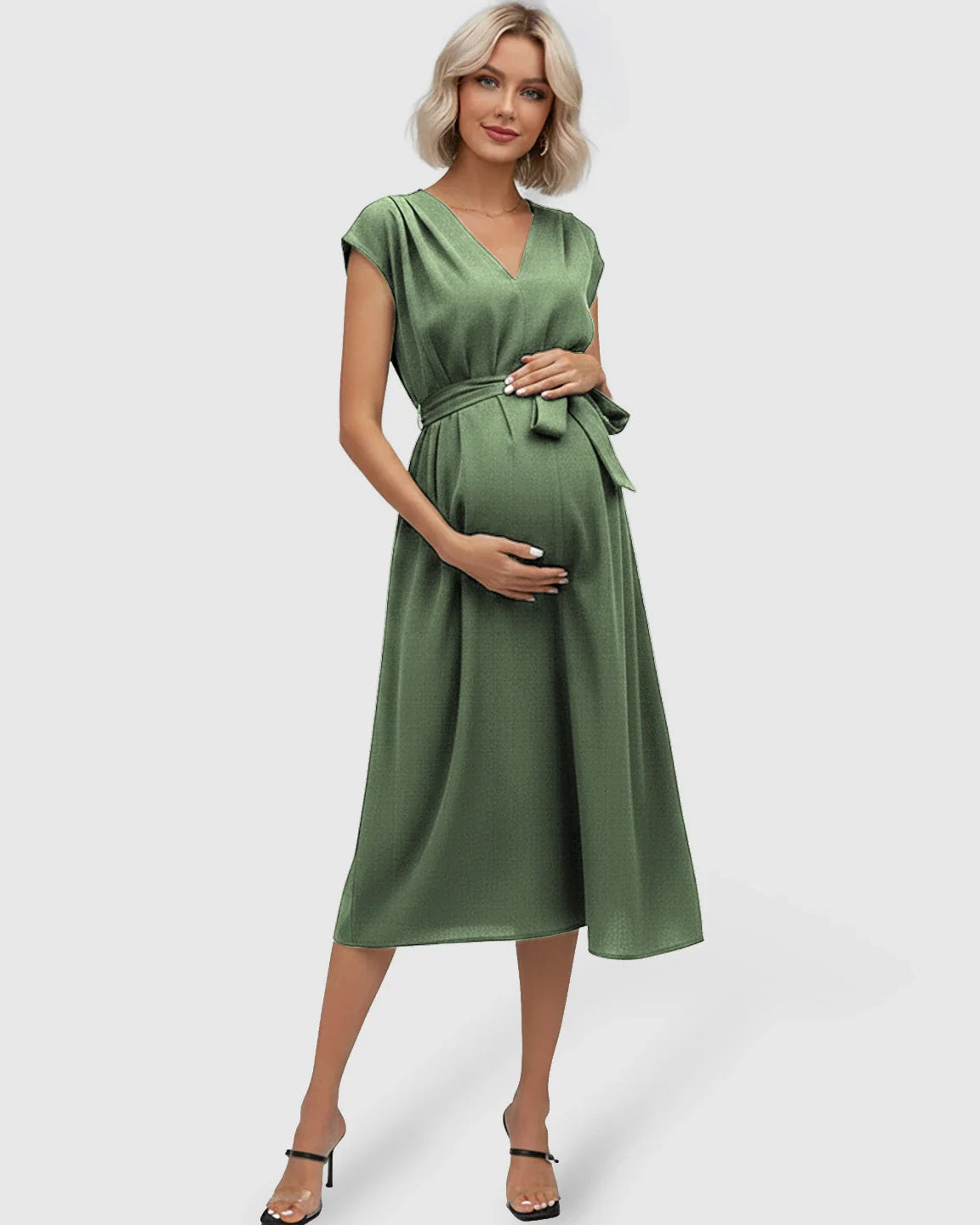 Maternity midi dress in olive green with V-neck, flutter sleeves, and tie-waist, worn by a pregnant woman.