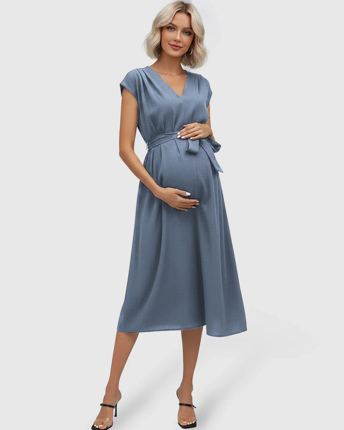 Maternity midi dress in slate blue with V-neck, flutter sleeves, and adjustable tie-waist, worn by a pregnant woman.