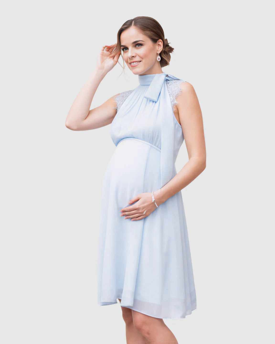 Light blue chiffon maternity midi dress with high neck, tie detail, and lace shoulders.