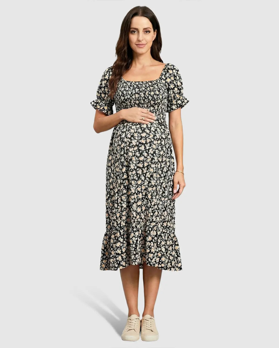 Maternity midi dress in black floral print with flutter sleeves, smocked top, and tiered skirt.