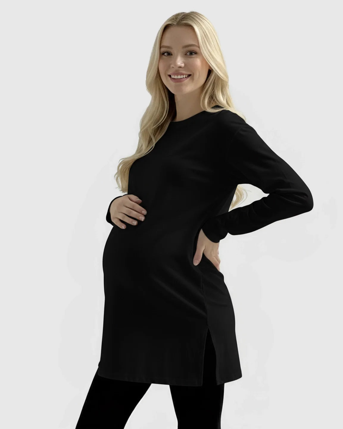 Smiling pregnant woman in a black long-sleeve soft cotton maternity top with side slits.