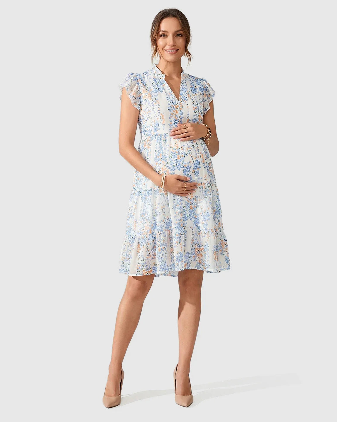 White A-line maternity dress with blue and orange floral print, flutter sleeves, and V-neck.
